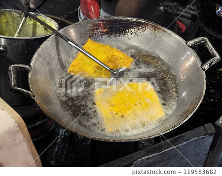 Fried omelet are fried in a steel skillet. Fried omelet are fried in a steel skillet. 119583682