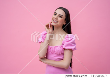 Pretty young long-haired woman in pink dress looking dreamy 119583806