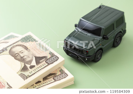 Toy car and stack of bills on green screen 119584309