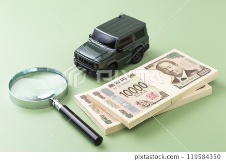 Toy car and stack of bills on green screen 119584350