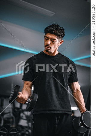 Man training with dumbbells at the gym Man training with dumbbells at the gym 119585120