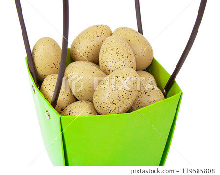 Bird eggs decorated in green basket isolated on the white background 119585808