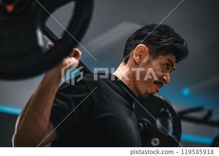 Man weight training with barbell at gym Man weight training with barbell at gym 119585918