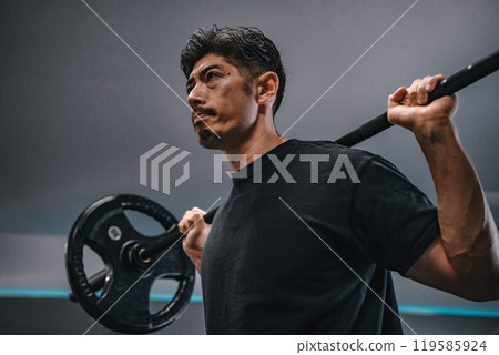 Man weight training with barbell at gym 119585924