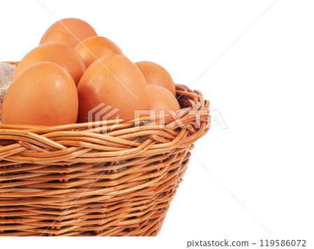 Hen natural eggs in wooden basket isolated on the white Hen natural eggs in wooden basket isolated on the white 119586072