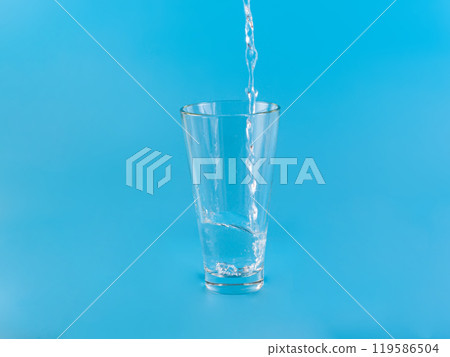 Glass with water aqua on blue background 119586504