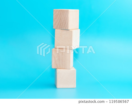 Wooden cube on blue background with space for text Wooden cube on blue background with space for text 119586567