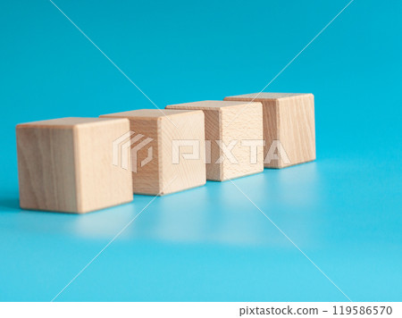 Wooden cube on blue background with space for text 119586570