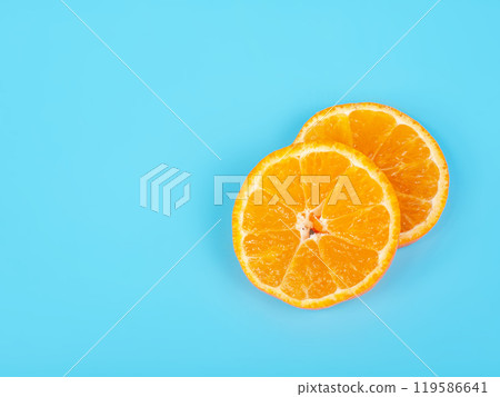 Orange tangerine slice on blue background 119586641