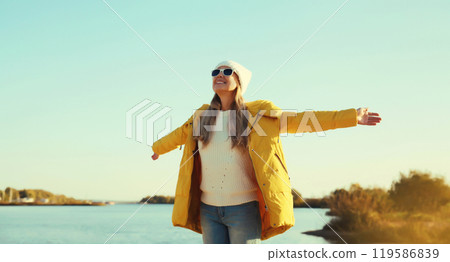 Happy smiling woman on sunny beach, joyful girl enjoying landscape, warm weather on sea coast 119586839