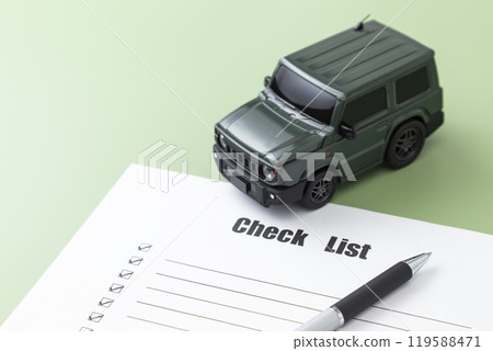Car and check sheet on green background 119588471