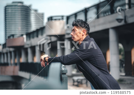 A man looking serious on a bridge A man looking serious on a bridge 119588575
