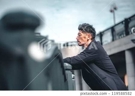 A man looking serious on a bridge 119588582