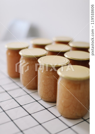 apple jam in jar on a light background in rustic style 119588606