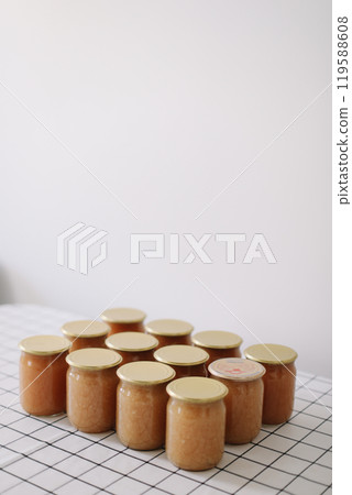 apple jam in jar on a light background in rustic style 119588608