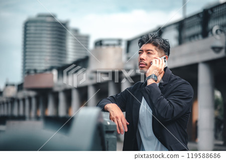 Man talking on mobile phone outdoors 119588686