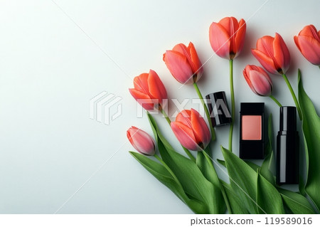 Cosmetic products arranged with red tulips on a white background creating an elegant display 119589016