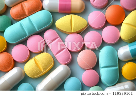 Colorful round candy pieces arranged on a light blue surface in a playful pattern 119589101