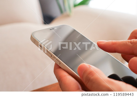 Women's hand with smartphone Women's hand with smartphone 119589443