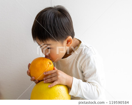 Boy holding fruit 119590584