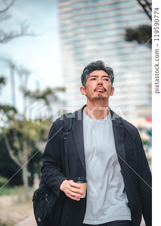 A man commuting through an office district 119590774