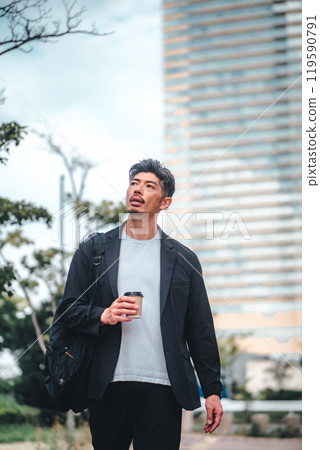 A man commuting through an office district 119590791