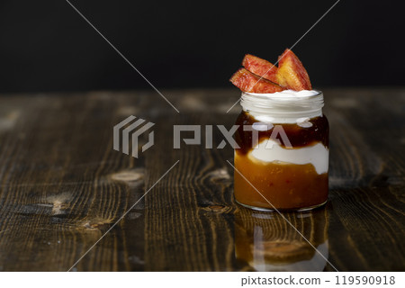 natural yogurt in a glass jar with fruits 119590918