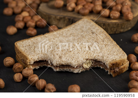 hazelnuts and bread with nut paste with chocolate hazelnuts and bread with nut paste with chocolate 119590958