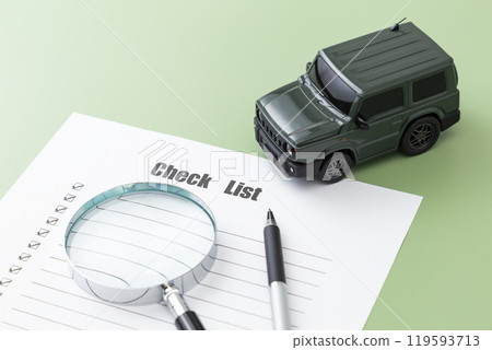 Car and check sheet on green background Car and check sheet on green background 119593713