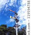 A semaphore signal shining against the blue sky 119594788
