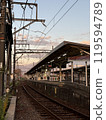 Japanese train station and tracks illuminated by the sunset 119594789