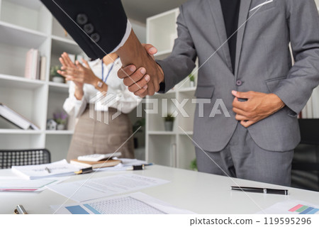 Professional Business Team Shaking Hands in Modern Office Setting, Celebrating Successful Partnership and Collaboration Professional Business Team Shaking Hands in Modern Office Setting, Celebrating Successful Partnership and Collaboration 119595296