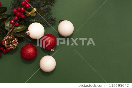 New Year's red and white shiny balls, fir branch on a dark green background with space for text 119595642