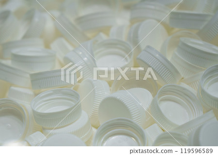 The pile of red plastic caps of drinking water bottles. The pile of red plastic caps of drinking water bottles. 119596589