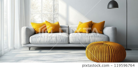 Modern living room with light gray sofa and yellow accent pillows illuminated by floor lamp 119596764