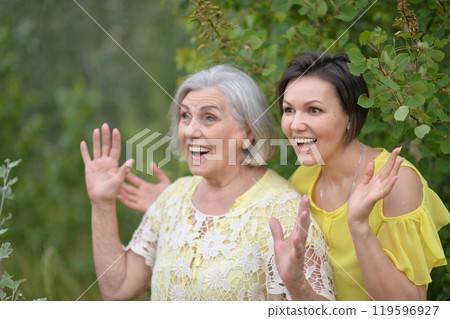 Portrait of an elderly woman with her daughter in the park Portrait of an elderly woman with her daughter in the park 119596927
