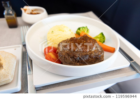 Delicious business class meal, beef tenderloin steak with mustard sauce and potato puree 119596944