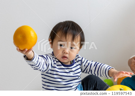 Boy holding fruit 119597543