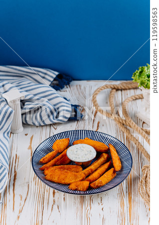 Crispy sweet potato fries with herb dip, perfect for a healthy snack or side dish Crispy sweet potato fries with herb dip, perfect for a healthy snack or side dish 119598563
