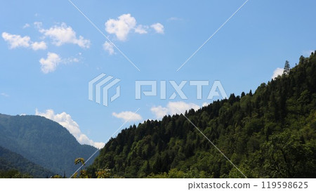 mountains covered with green forest, rolling hills stretching into the distance, view of the foothills of the Caucasus, green hills under a clear sky mountains covered with green forest, rolling hills stretching into the distance, view of the foothills of the Caucasus, green hills under a clear sky 119598625