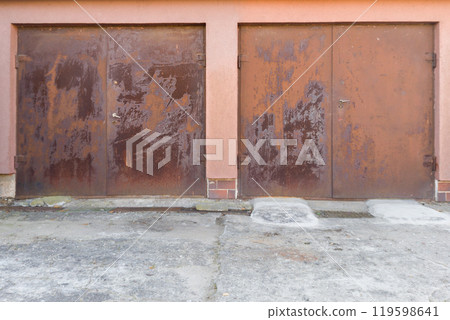 Two rusted metal doors with weathered surface 119598641