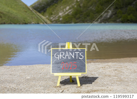 Planning grants 2025 new year symbol. Concept words Grants 2025 on beautiful yellow chalk blackboard. Beautiful mountain lake sand beach background. Business grants 2025 new year concept. Copy space. 119599317