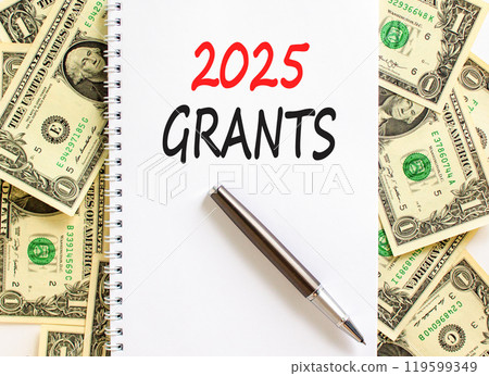 Planning 2025 grants new year symbol. Concept words 2025 Grants on beautiful white note. Beautiful background from dollar bills. Black pen. Business 2025 grants new year concept. Copy space. 119599349
