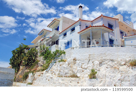 Traditional Greek architecture with white houses, blue doors and shutters Traditional Greek architecture with white houses, blue doors and shutters 119599500