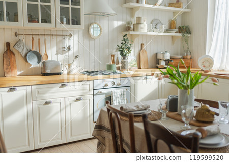 Scandinavian classic minimalistic kitchen with white and wooden details flowers. Modern white kitchen clean contemporary style interior design. Empty bright white interior minimal of kitchen 119599520