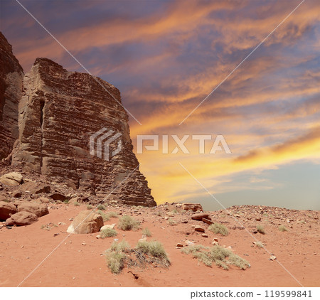 Wadi Rum Desert also known as The Valley of the Moon (against the sky with clouds)-- is a valley cut into the sandstone and granite rock in southern Jordan 60 km to the east of Aqaba Wadi Rum Desert also known as The Valley of the Moon (against the sky with clouds)-- is a valley cut into the sandstone and granite rock in southern Jordan 60 km to the east of Aqaba 119599841
