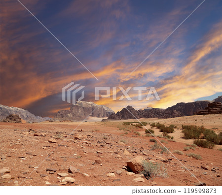Wadi Rum Desert also known as The Valley of the Moon (against the sky with clouds)-- is a valley cut into the sandstone and granite rock in southern Jordan 60 km to the east of Aqaba 119599873