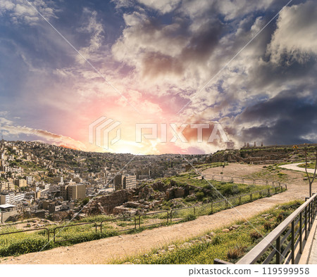 Amman city landmarks-- old roman Citadel Hill, Jordan. Against the background of a beautiful sky with clouds Amman city landmarks-- old roman Citadel Hill, Jordan. Against the background of a beautiful sky with clouds 119599958