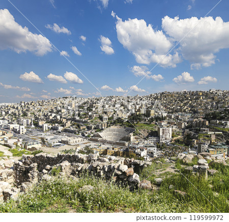 Amman city landmarks-- old roman Citadel Hill, Jordan. Against the background of a beautiful sky with clouds Amman city landmarks-- old roman Citadel Hill, Jordan. Against the background of a beautiful sky with clouds 119599972