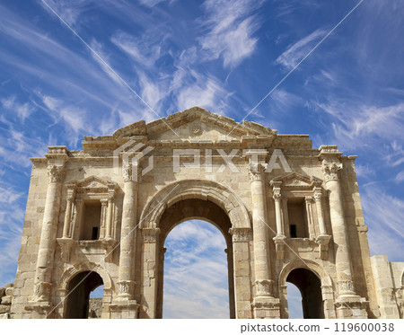 Arch of Hadrian in Gerasa (Jerash)-- was built to honor the visit of emperor Hadrian to Jerash in 129/130 AD, Jordan. Against the background of a beautiful sky with clouds Arch of Hadrian in Gerasa (Jerash)-- was built to honor the visit of emperor Hadrian to Jerash in 129/130 AD, Jordan. Against the background of a beautiful sky with clouds 119600038